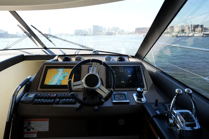 Slide: The Image of Cockpit view of 2016 Prestige 550 yacht with navigation screens and steering wheel. - 65