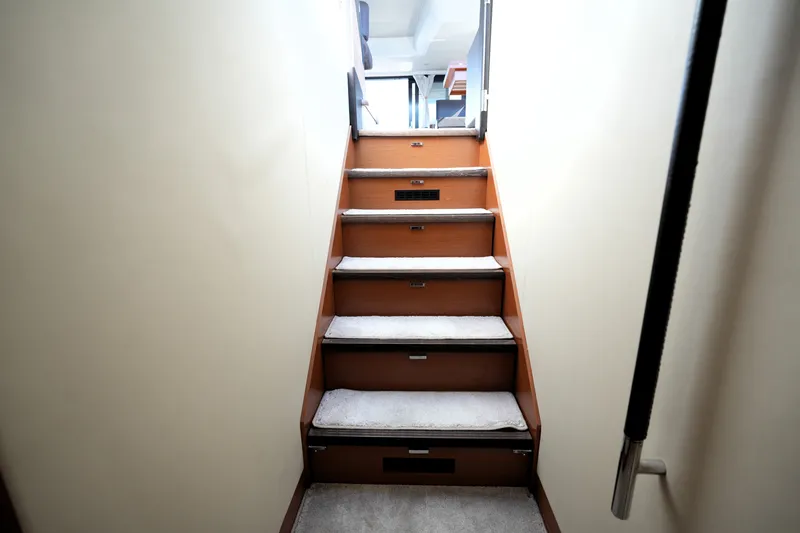 Slide: The Image of Staircase inside 2016 Prestige 550 yacht, featuring carpeted steps and sleek design. - 88