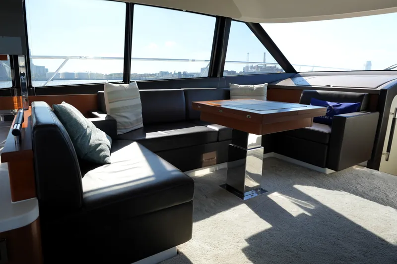 Slide: The Image of Luxurious interior of 2016 Prestige 550 yacht with plush seating and panoramic windows. - 58