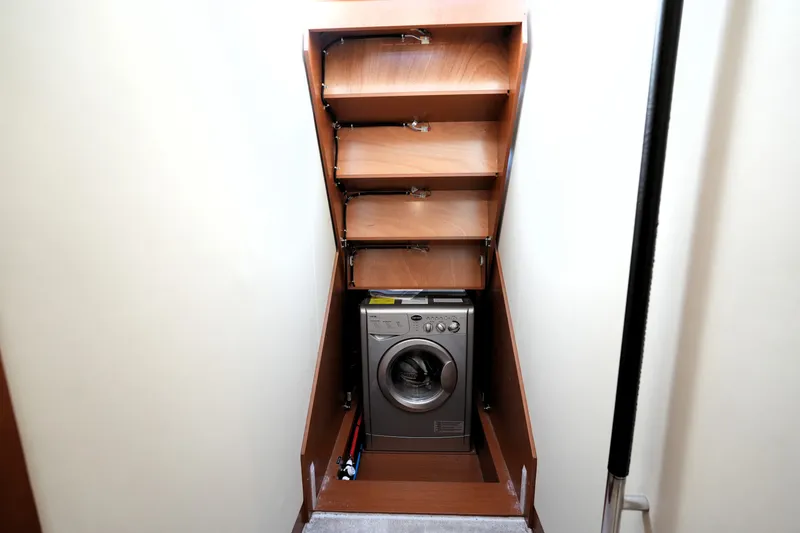 Slide: The Image of Compact laundry area with washing machine in 2016 Prestige 550 yacht. - 89