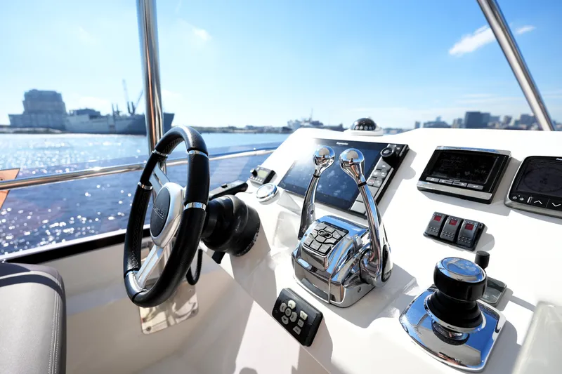 Slide: The Image of Control panel of a 2016 Prestige 550 yacht with steering wheel and navigation instruments. - 35