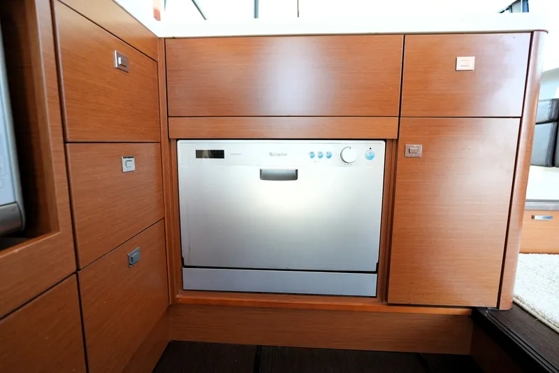Slide: The Image of Modern kitchen cabinetry with built-in dishwasher on a 2016 Prestige 550 yacht. - 52