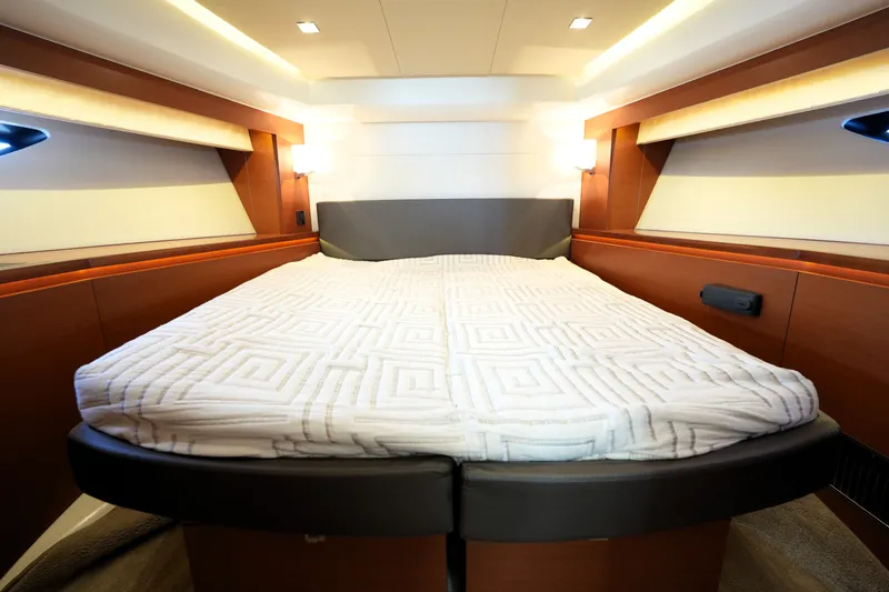 Slide: The Image of Luxurious bedroom interior of a 2016 Prestige 550 yacht with elegant wood finishes. - 90
