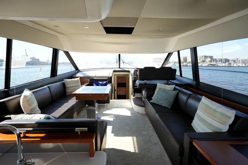 Slide: The Image of Luxurious interior of a 2016 Prestige 550 yacht with panoramic windows and elegant seating. - 54