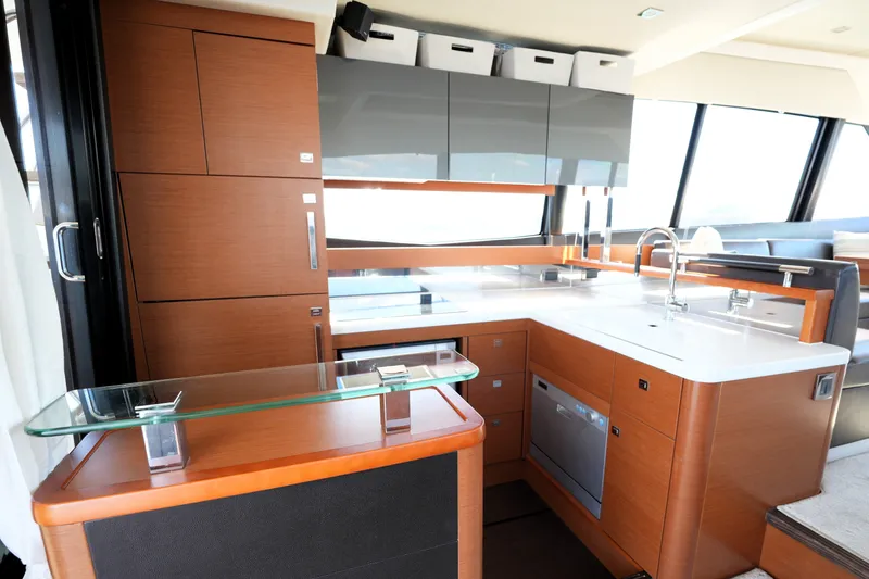 Slide: The Image of Luxurious kitchen interior of a 2016 Prestige 550 yacht with modern cabinetry and appliances. - 46