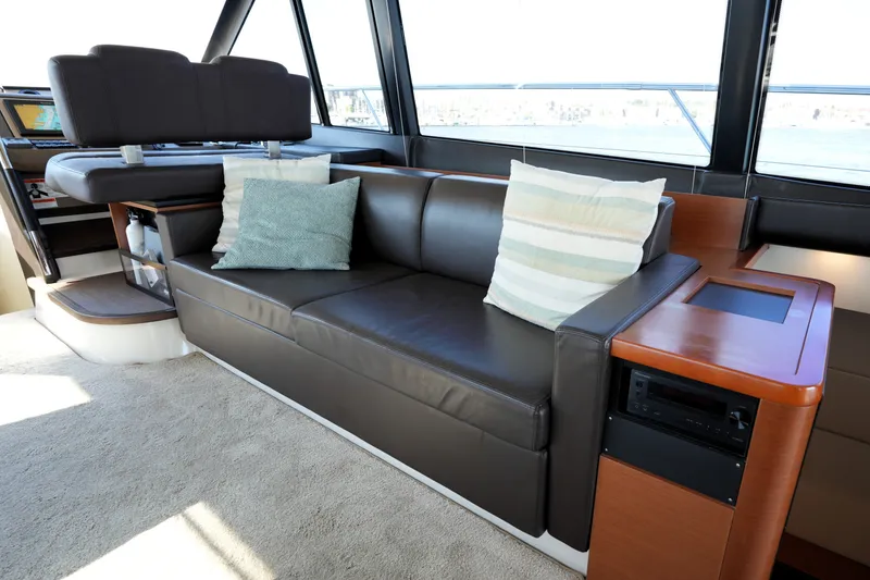 Slide: The Image of Luxurious interior of 2016 Prestige 550 yacht with leather seating and decorative pillows. - 55