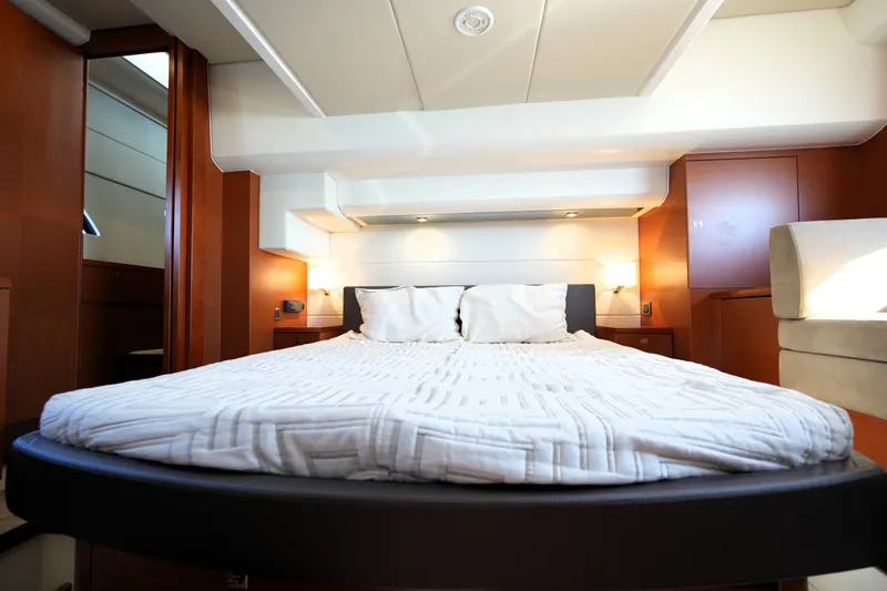 Slide: The Image of Luxurious bedroom interior of 2016 Prestige 550 yacht, featuring elegant wood finishes and modern lighting. - 77