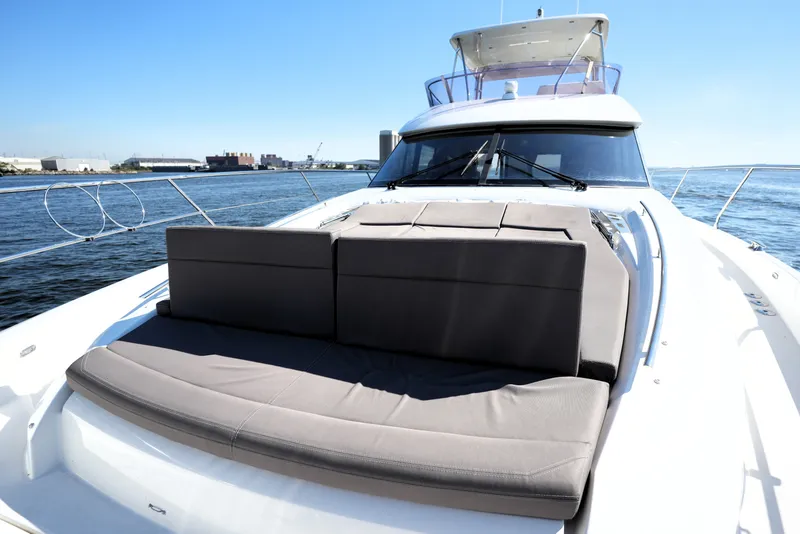 Slide: The Image of Luxury 2016 Prestige 550 yacht with spacious deck seating on open water. - 23