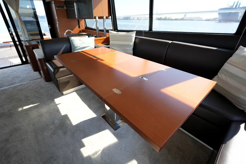 Slide: The Image of Luxurious interior of 2016 Prestige 550 yacht with elegant dining area and scenic window views. - 61