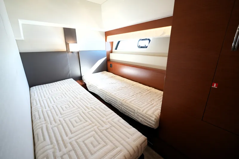 Slide: The Image of Interior of 2016 Prestige 550 yacht featuring twin beds in a modern cabin. - 95