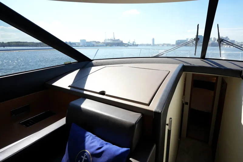 Slide: The Image of Interior view of 2016 Prestige 550 yacht helm with cityscape in background. - 62