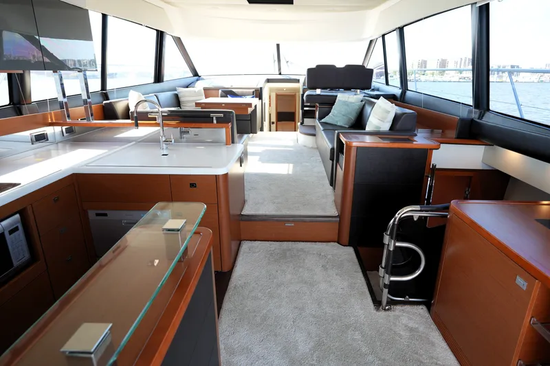 Slide: The Image of Luxurious interior of a 2016 Prestige 550 yacht with modern kitchen and seating area. - 41