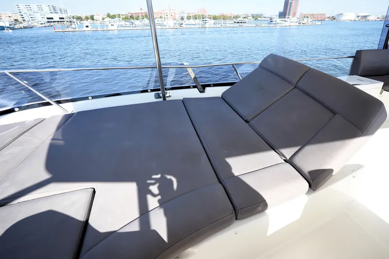 Slide: The Image of Luxurious sunbed on 2016 Prestige 550 yacht, overlooking serene waterfront marina. - 31
