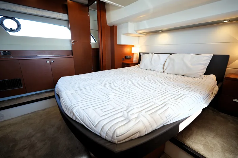 Slide: The Image of Luxurious bedroom interior of 2016 Prestige 550 yacht with modern design and cozy bedding. - 76