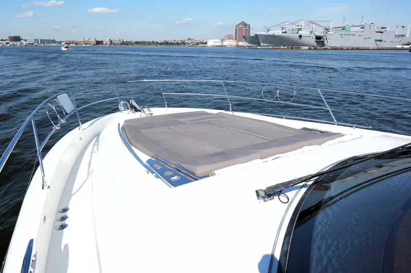 Slide: The Image of 2016 Prestige 550 yacht cruising on a sunny day with cityscape in the background. - 20