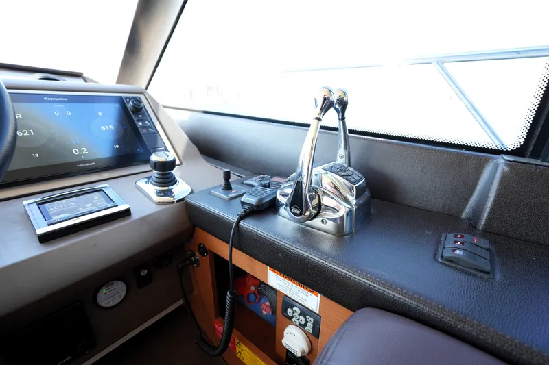Slide: The Image of Control panel of a 2016 Prestige 550 yacht featuring navigation and throttle controls. - 70