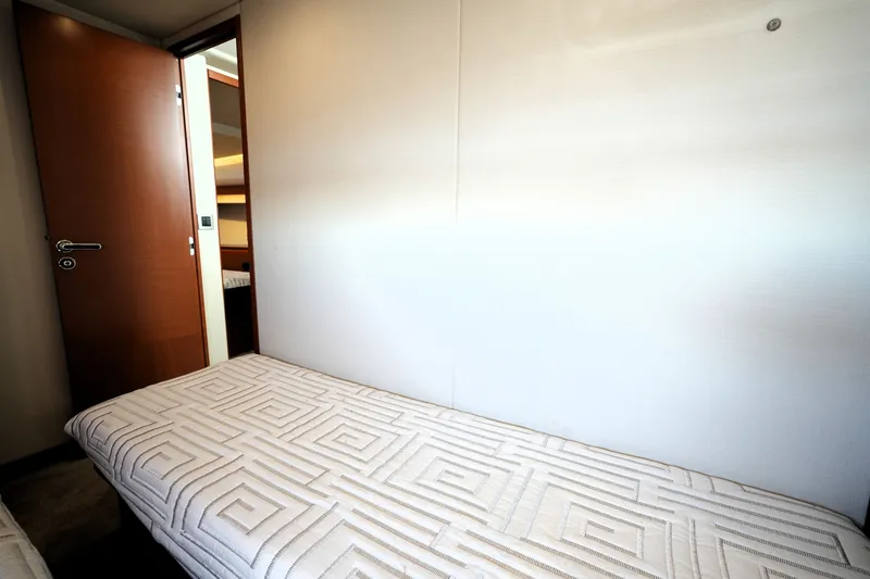 Slide: The Image of Interior cabin of 2016 Prestige 550 yacht with modern bedding and wooden door. - 97