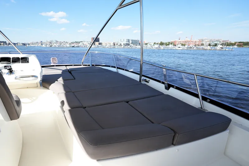 Slide: The Image of Luxurious 2016 Prestige 550 yacht deck with sun loungers overlooking a scenic waterfront. - 29