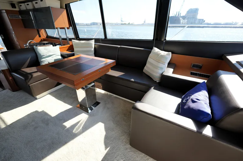 Slide: The Image of Luxurious interior of a 2016 Prestige 550 yacht with elegant seating and a wooden table. - 59