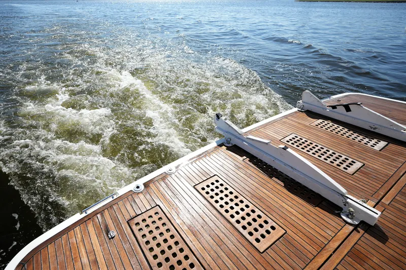 Slide: The Image of Sleek 2016 Prestige 550 yacht deck with wooden finish cruising on open water. - 15