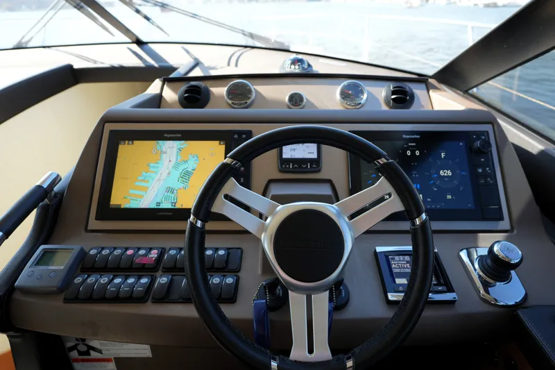 Slide: The Image of Cockpit of 2016 Prestige 550 yacht with navigation screens and steering wheel. - 66