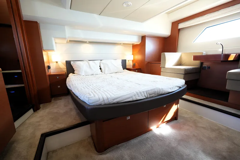 Slide: The Image of Luxurious bedroom interior of a 2016 Prestige 550 yacht, featuring a cozy bed and elegant furnishings. - 74