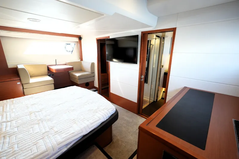 Slide: The Image of Luxurious interior of a 2016 Prestige 550 yacht featuring a cozy bedroom and modern amenities. - 75