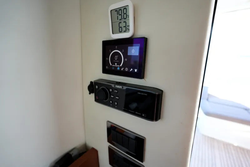 Slide: The Image of Control panel on a 2016 Prestige 550 yacht, featuring temperature and navigation displays. - 45
