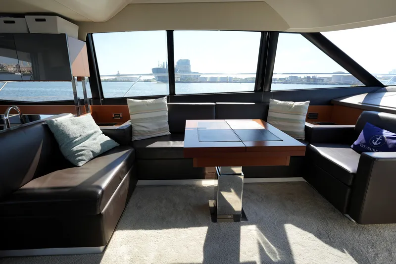Slide: The Image of Luxurious interior of a 2016 Prestige 550 yacht with elegant seating and scenic ocean view. - 60