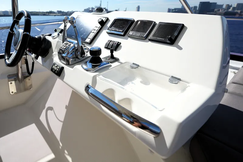 Slide: The Image of Control panel of a 2016 Prestige 550 yacht with steering wheel and navigation instruments. - 37