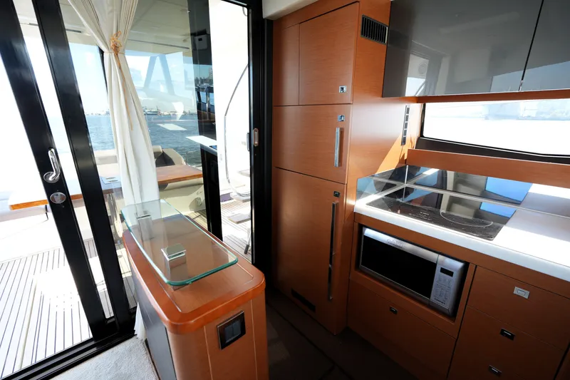 Slide: The Image of Modern kitchen interior on 2016 Prestige 550 yacht, featuring sleek cabinetry and appliances. - 53
