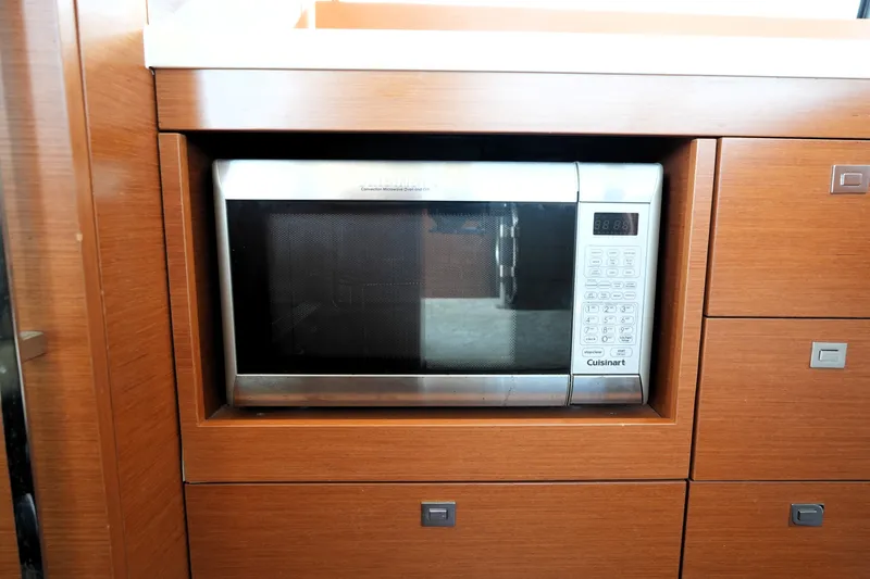 Slide: The Image of Built-in Cuisinart microwave in 2016 Prestige 550 yacht's wooden cabinetry. - 51