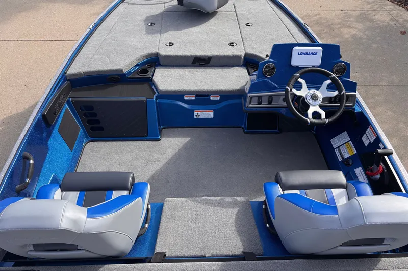 Slide: The Image of 2027 Nitro Z18 XL boat interior with blue and gray seating, steering wheel, and dashboard. - 8