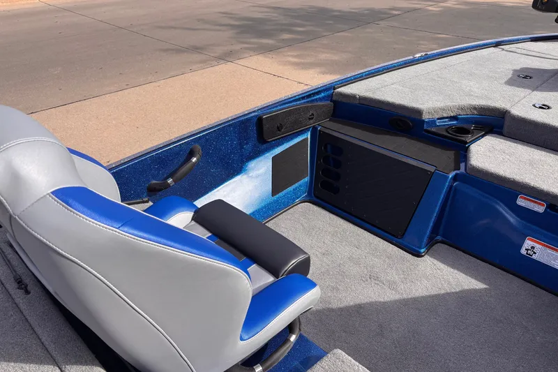 Slide: The Image of 2027 Nitro Z18 XL boat interior with blue and gray seating, carpeted deck, and storage compartments. - 6
