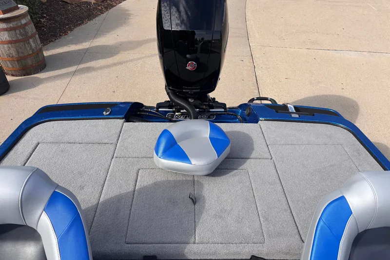 Slide: The Image of 2027 Nitro Z18 XL boat interior with blue and gray seating and motor. - 9