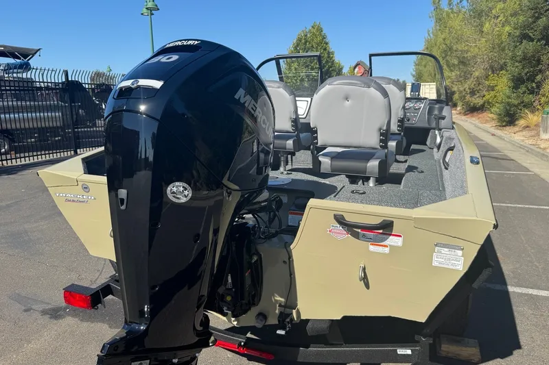 Slide: The Image of 2027 Tracker Pro Guide V-16 WT boat with Mercury engine, parked outdoors. - 13