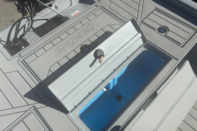 Slide: The Image of 2027 Tracker Bass Tracker 175 CC boat deck with open storage compartment. - 13