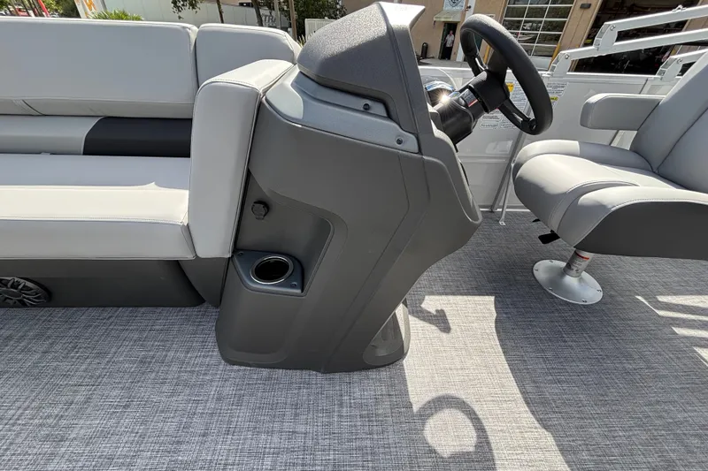 Slide: The Image of 2027 Sun Tracker Party Barge 20 DLX interior with steering console and seating. - 14