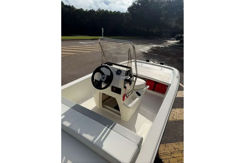 Slide: The Image of 2026 Mako Pro Skiff 13 CC boat interior with steering console and seating. - 6