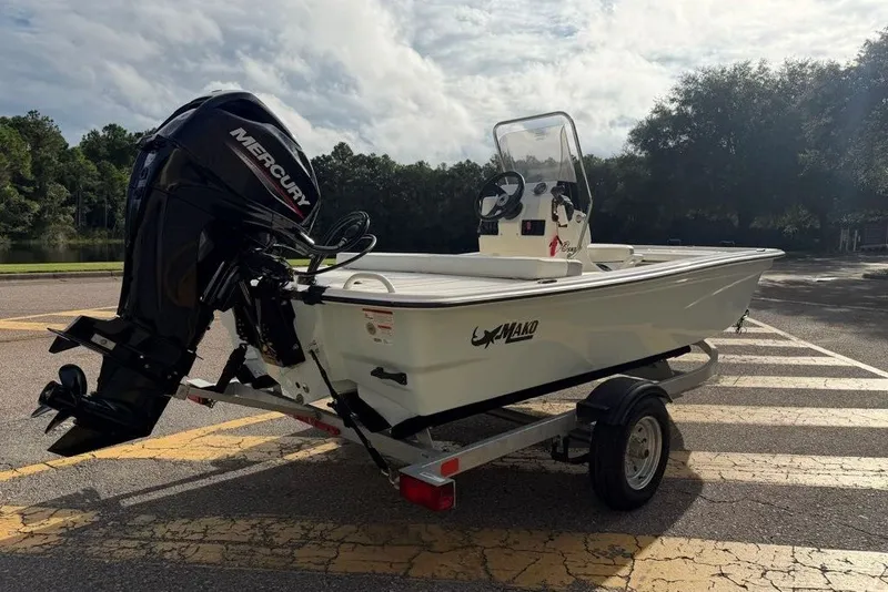 Slide: The Image of 2026 Mako Pro Skiff 13 CC boat on trailer with Mercury outboard motor. - 4