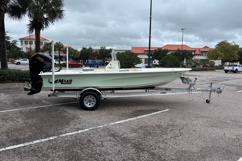Slide: The Image of 2026 Mako 18 Pro Skiff on trailer in parking lot, overcast sky. - 1