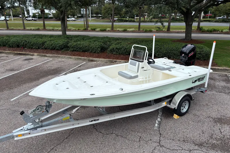 Slide: The Image of 2026 Mako 18 Pro Skiff boat on trailer in parking lot. - 6