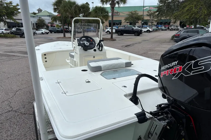 Slide: The Image of 2026 Mako 18 Pro Skiff boat with Mercury Pro XS engine in parking lot. - 9