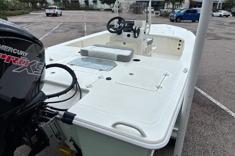 Slide: The Image of 2026 Mako 18 Pro Skiff boat with Mercury Pro XS engine in parking lot. - 10