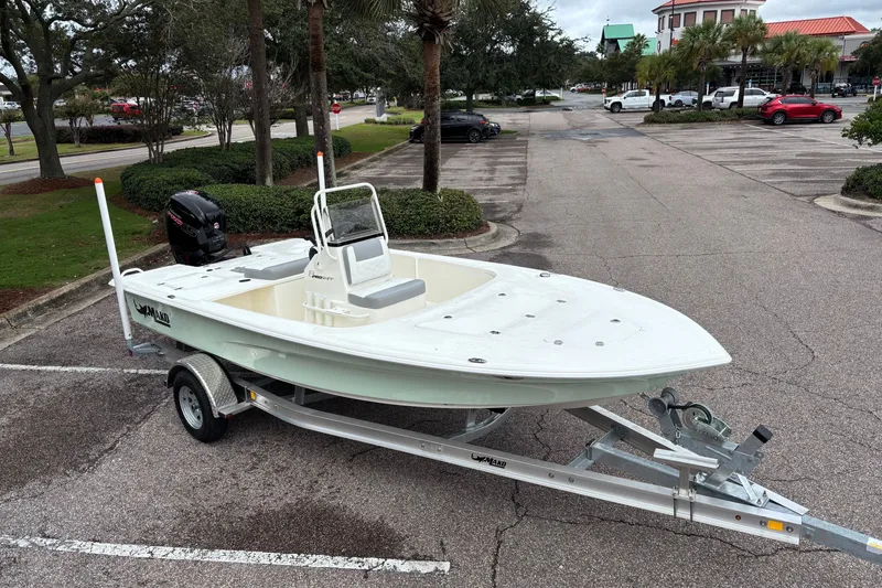 Slide: The Image of 2026 Mako 18 Pro Skiff on trailer in parking lot, ready for adventure. - 5