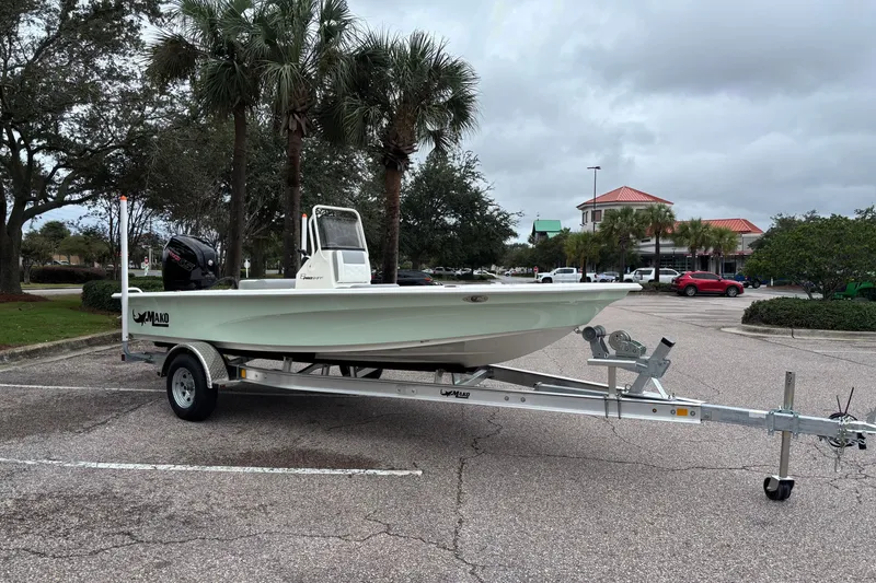 Slide: The Image of 2026 Mako 18 Pro Skiff boat on trailer in parking lot with palm trees. - 3