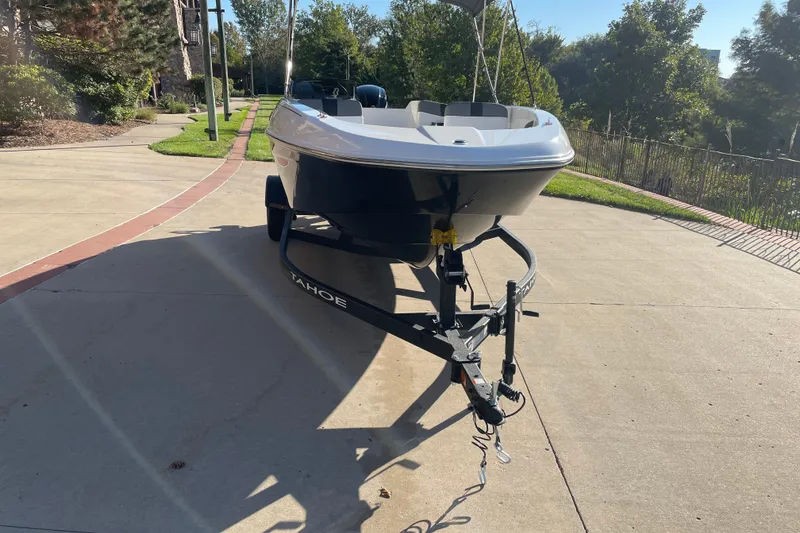 Slide: The Image of 2027 Tahoe T18 boat on trailer in sunny driveway setting. - 3