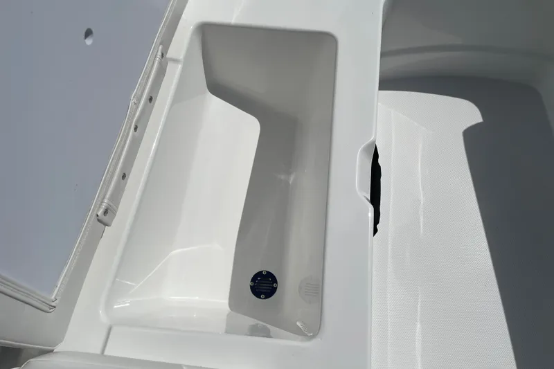 Slide: The Image of Storage compartment of 2027 Tahoe T21 boat, featuring sleek white interior design. - 25