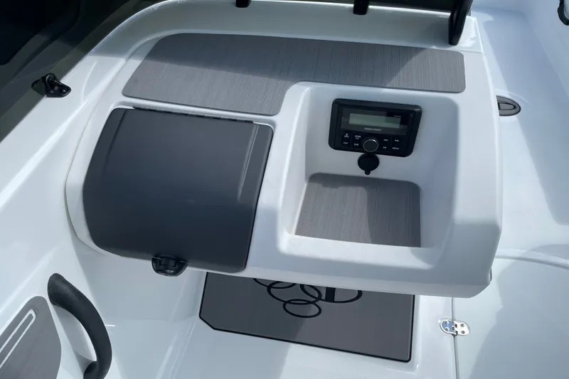 Slide: The Image of Dashboard of 2027 Tahoe T21 boat featuring a control panel and storage compartment. - 10