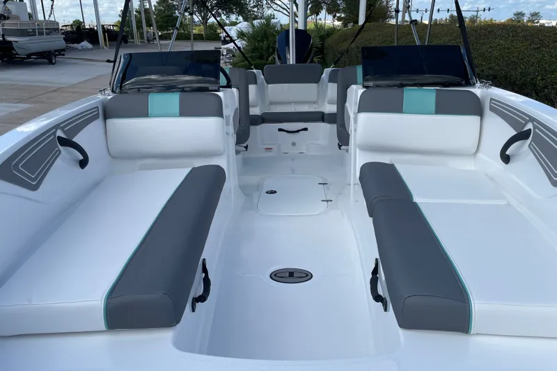 Slide: The Image of 2027 Tahoe T21 boat interior with sleek white and gray seating, outdoor setting. - 18